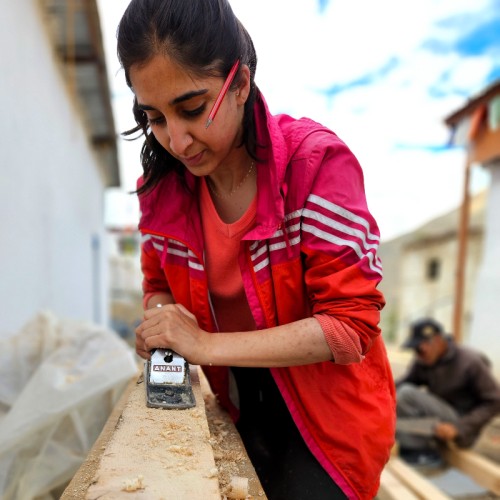 Young woman planing wood